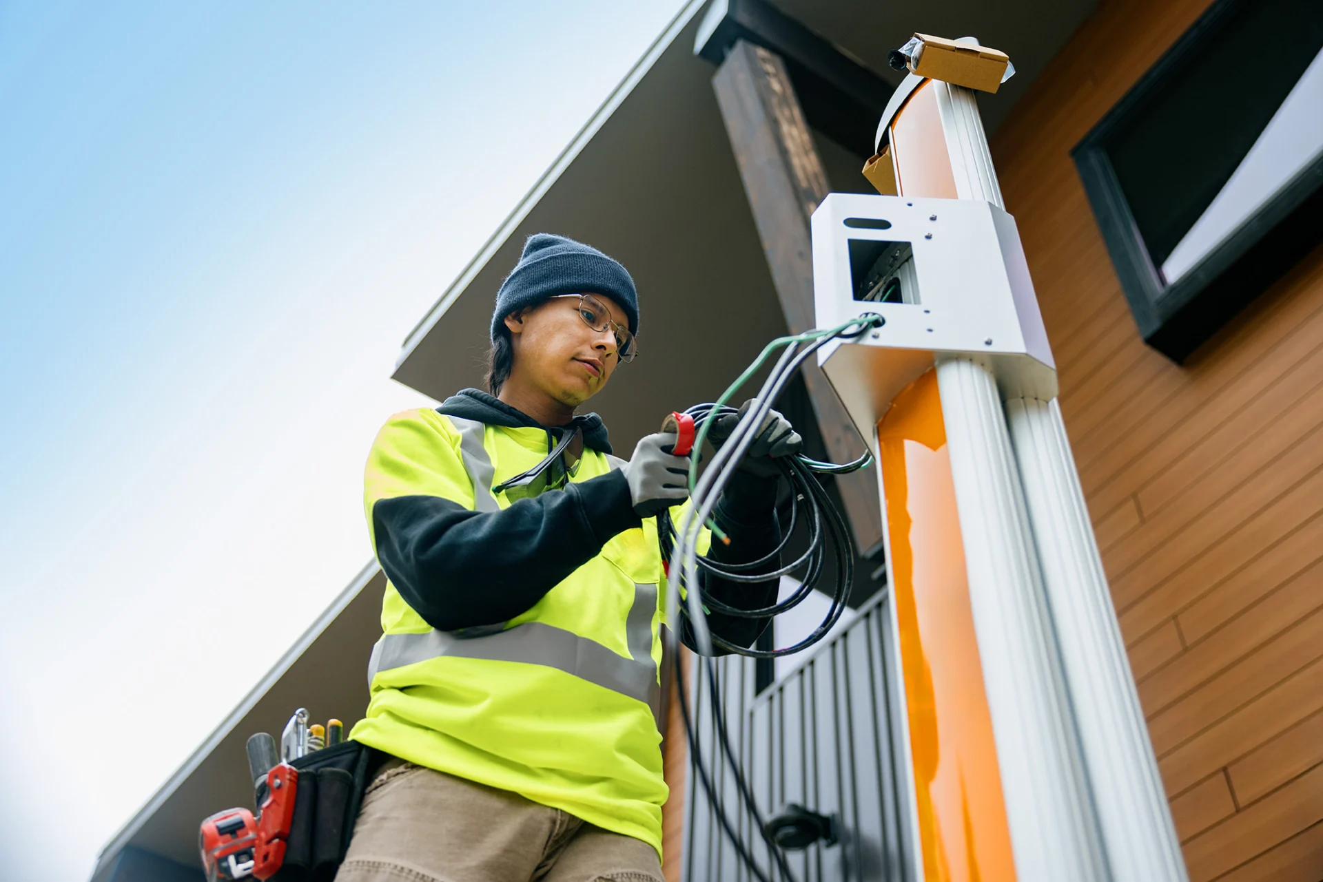 workman handling cables on vehicle charger